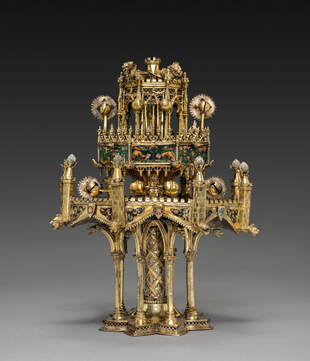 A sumptuous gilded table fountain from the fifteenth century. It features a host of intricate ornamentations, among which nonhuman animals.